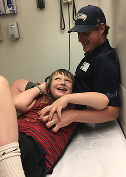 Eddie laying down with his head in his father's lap at the doctor's office