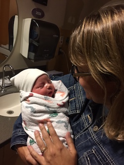 Emily Coleman holding her newborn nephew at the hospital 