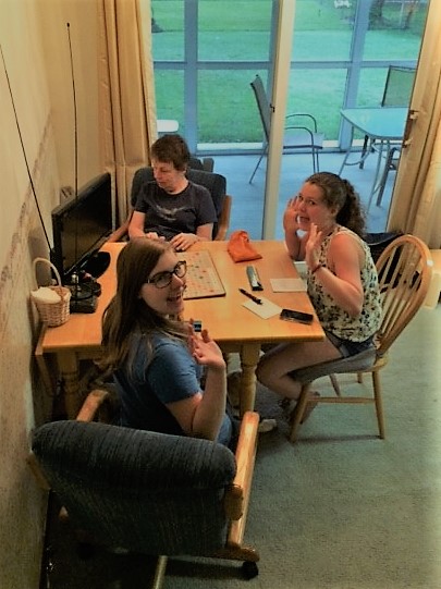 mary and teenage granddaughters playing scrabble