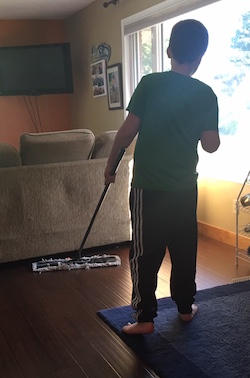 Eddie sweeping the living room floor