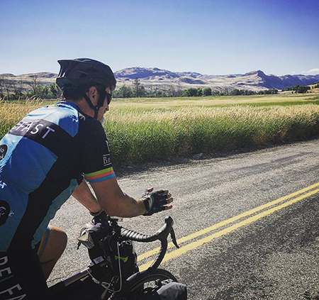 Mike Robertson from Shared Vision Quest riding his bike down the street