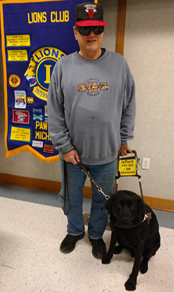 Herb Grassow standing with this Leader Dog, Baxter