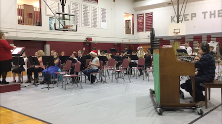 Eddie's sixth-grade band playing in a gym at school for the holiday concert