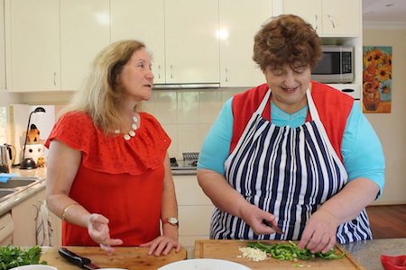 Maribel and Penny Melville-Brown cooking together in Maribel's kitchen, image from Toby Melville