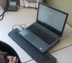 Braille display at a computer below the user's keyboard