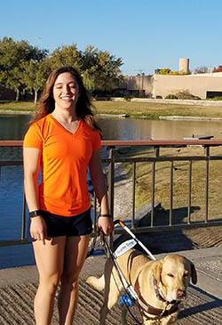 Letticia Martinez with her guide dog standing outside