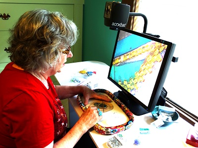 Lynda using acrobat to work on jewelry