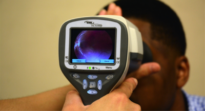 A camera being used on a patient to detect problems with the patient's eye