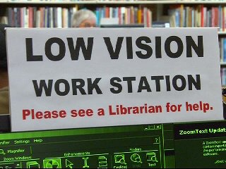 A photograph of a sign marking the low vision computer work stations in the Holland Library