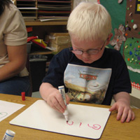 Four-year-old Zac sat on a chair 10 feet from Ms. Lundy, his teacher of students with visual impairments (TVI). As Ms. Lundy held up a card with a picture on it, Zac pointed to the corresponding picture on a puzzle he had in front of him. 