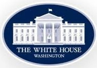The official White House logo. It pictures the White House on a blue background, inside a framed oval.