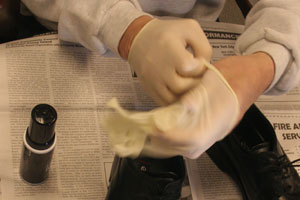 close up of man's hands as he puts on a surgical glove